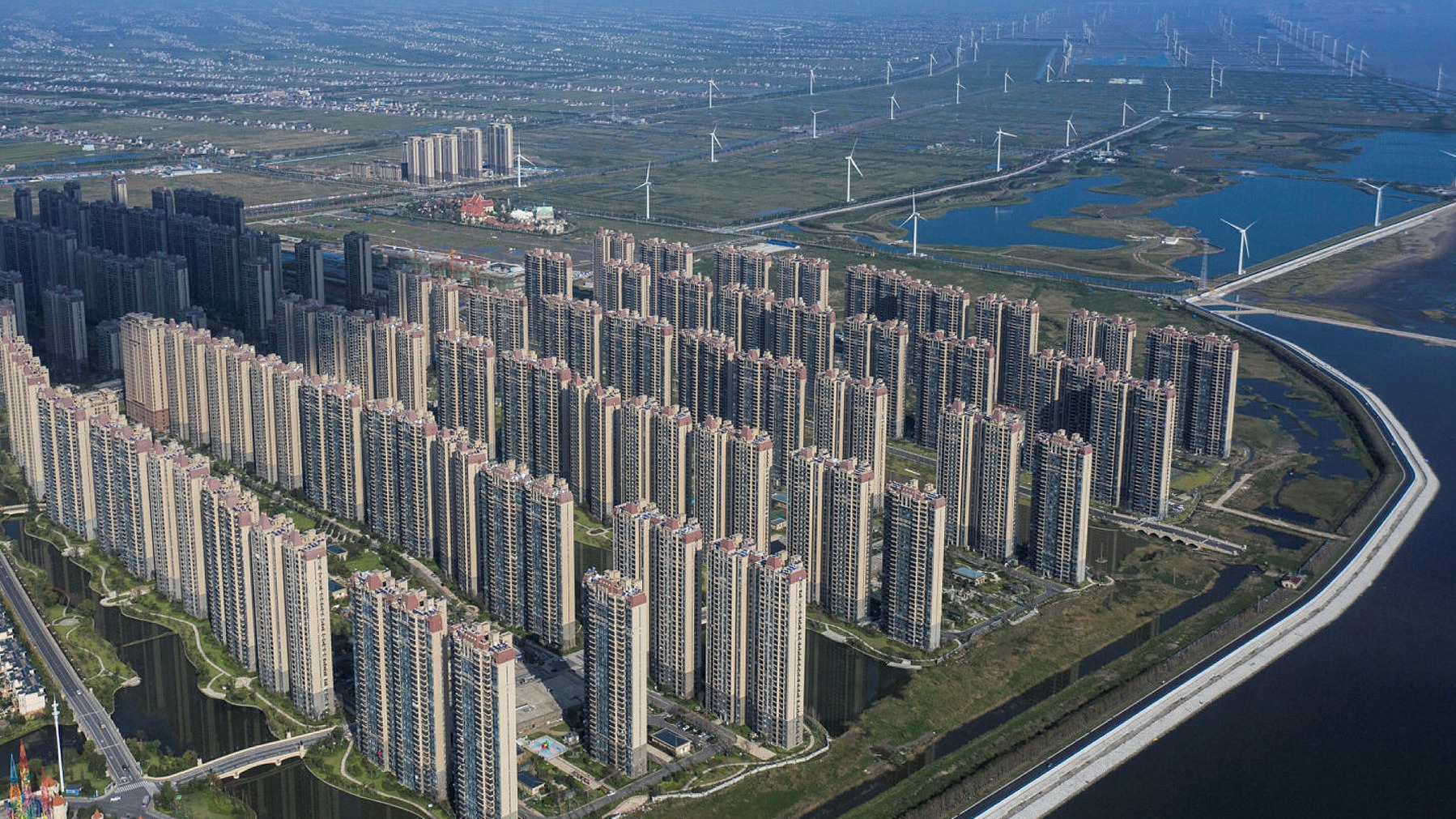 Bird's eye view of a large series of waterfront apartment blocks in Qidong, China.
